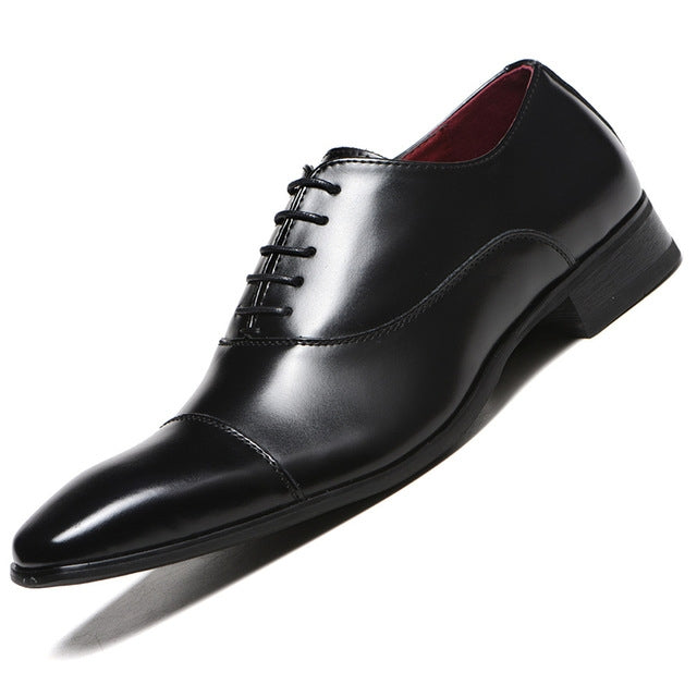 Black leather oxford dress shoe with lace-up front and black block heel