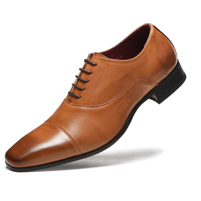 Brown leather lace-up oxford dress shoe with wingtip stitching and low block heel