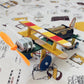 Electric wooden toy airplane model with colorful strip wings, black motor, and wheels