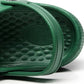 Green medical clog outsole tread close-up with raised non-slip texture
