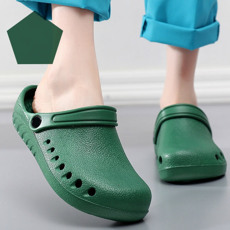 Green slip-on medical clogs on feet with perforations and heel strap