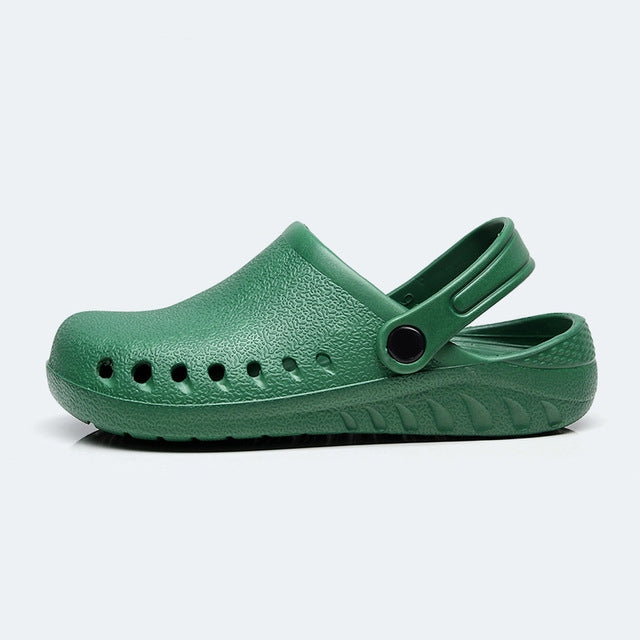 Green slip-on medical clog with side strap and perforated toe design