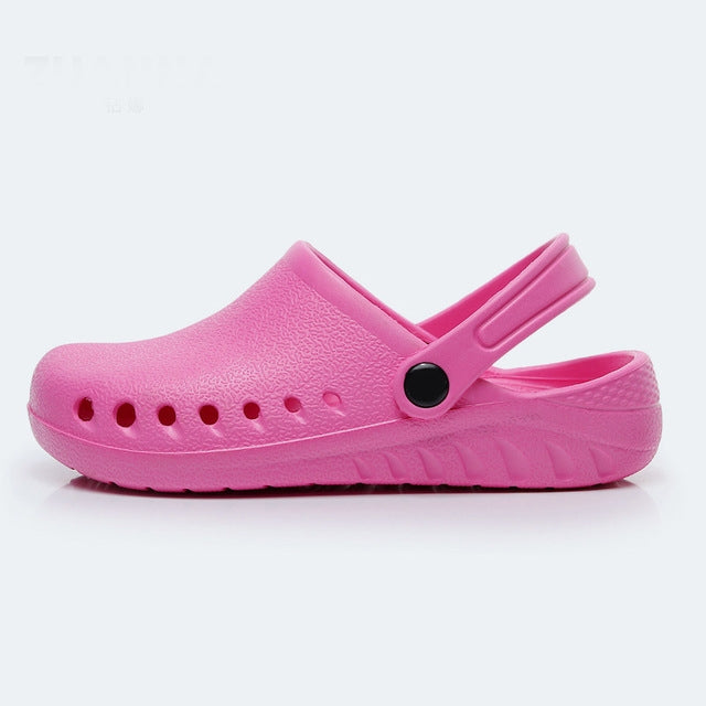 Pink slip-on nursing clog with heel strap, perforated toe, and textured upper