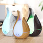 Teardrop aroma diffuser set with marble, light wood, dark wood finishes and LED glow