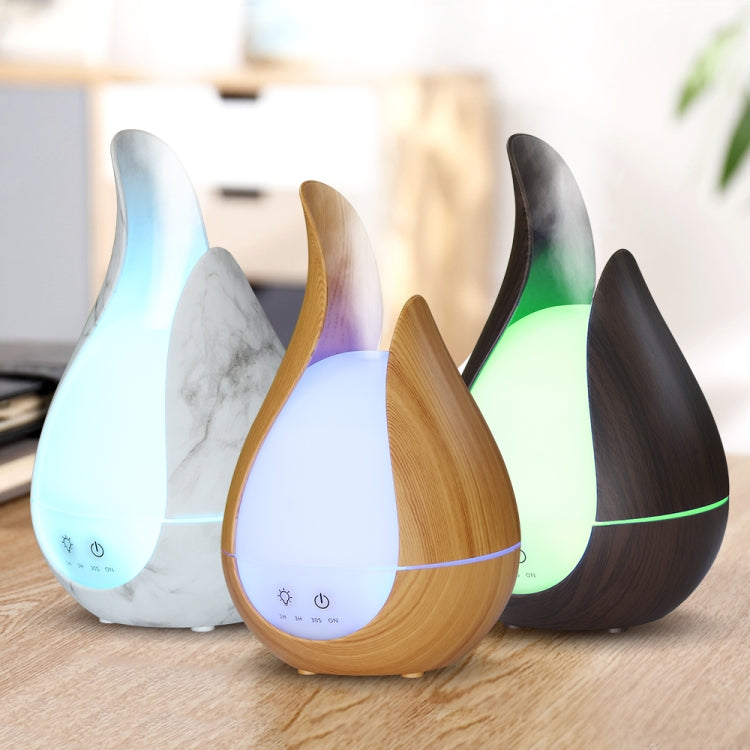 Teardrop aroma diffuser set with marble, light wood, dark wood finishes and LED glow