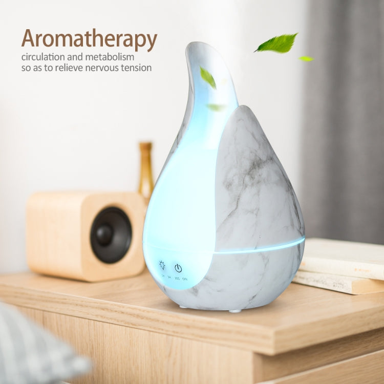 Marble-pattern teardrop aroma diffuser with blue LED glow and mist outlet