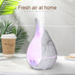 Marble-pattern teardrop aroma diffuser with purple LED glow