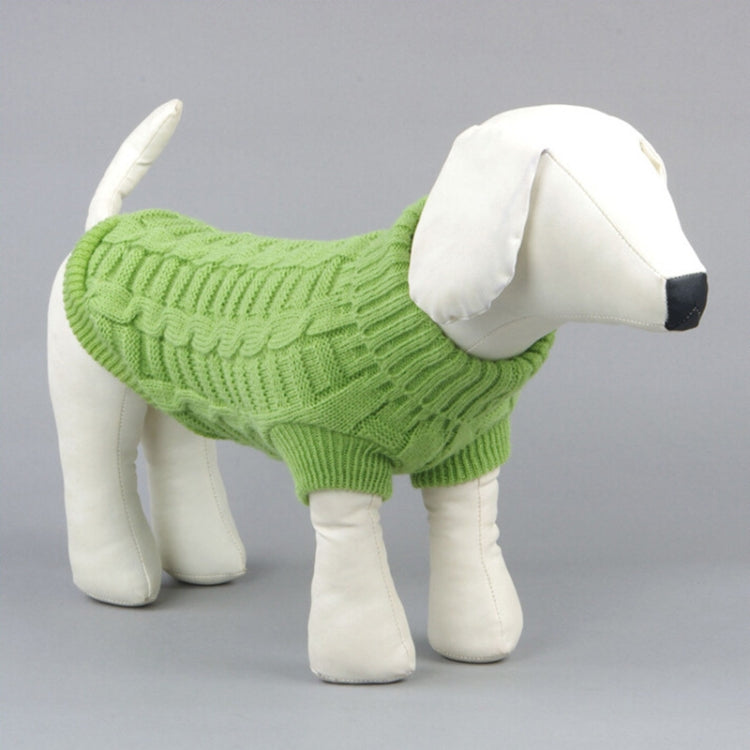 Green knitted dog sweater with ribbed cuffs and hem, cable knit texture.