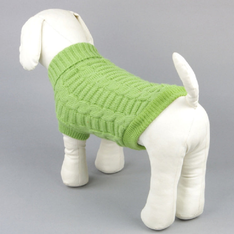 Green knitted dog sweater on all-fours dog, ribbed cuffs and cable pattern.