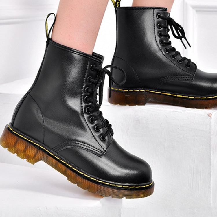 Black lace-up ankle boots with yellow stitching and padded collar, side view