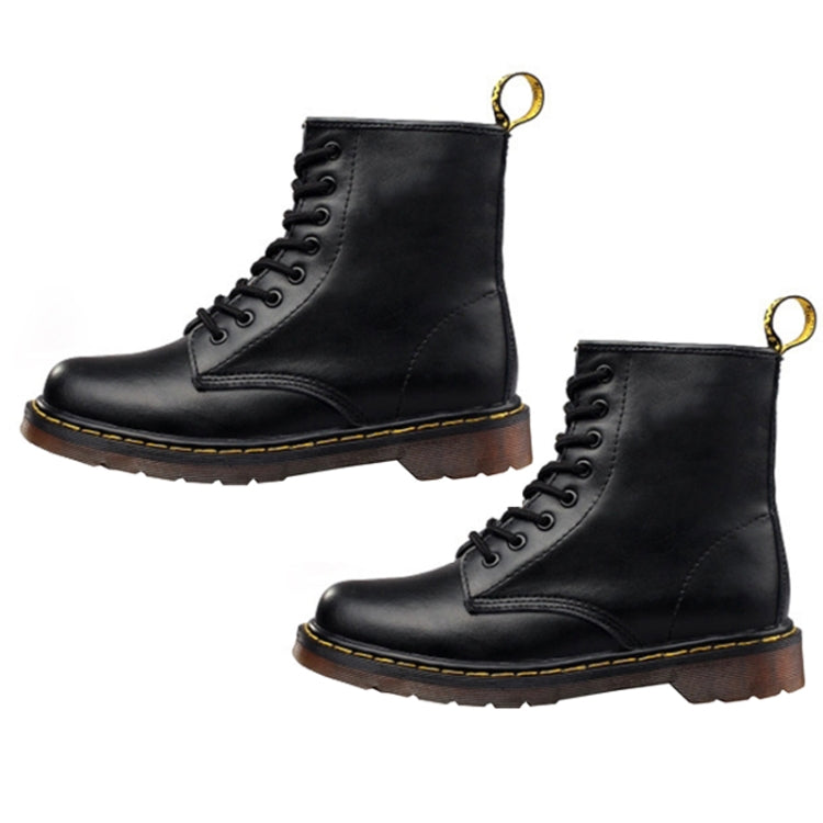 Two black lace-up boots with padded collar, chunky tread sole, and gold pull loop