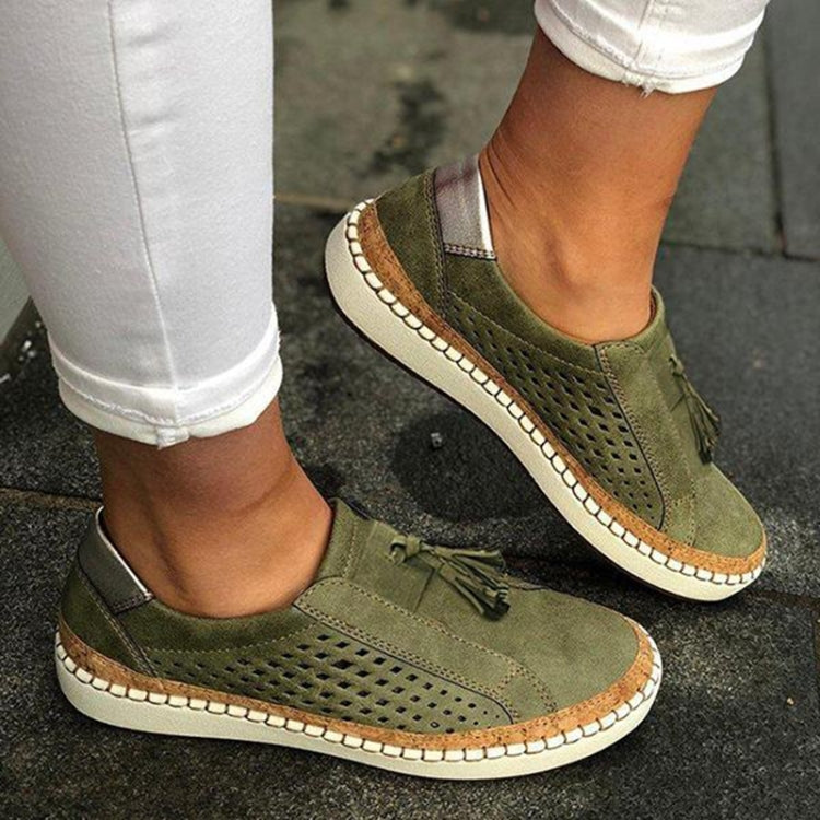 Olive green perforated slip-on flat sneakers with tasseled strap detail and white midsole