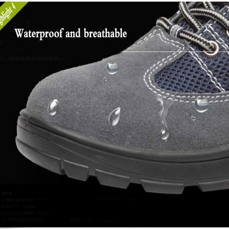 Close-up of gray and navy safety shoe upper with mesh panel and water droplets