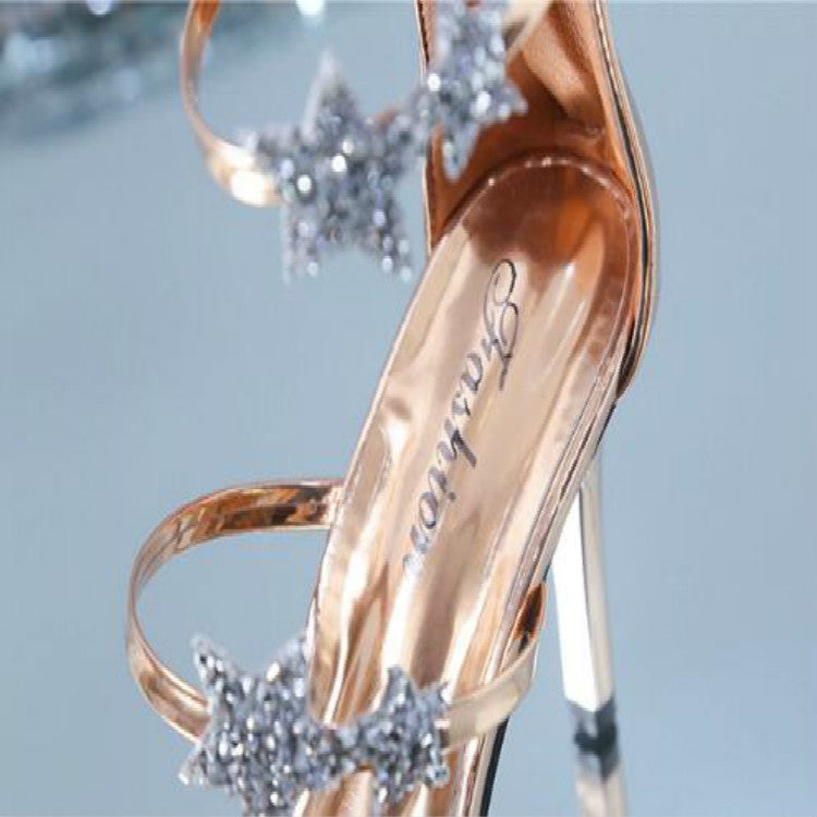 Champagne metallic high heel sandal with star embellishment on peep toe and clear strap
