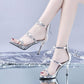 Silver peep-toe stiletto sandals with star embellishments and ankle straps
