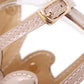 Close-up of gold-toned sandal strap with stitched trim and buckle detail