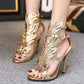 Gold metal wing peep-toe high heel sandals, sculpted wing overlay, ankle strap