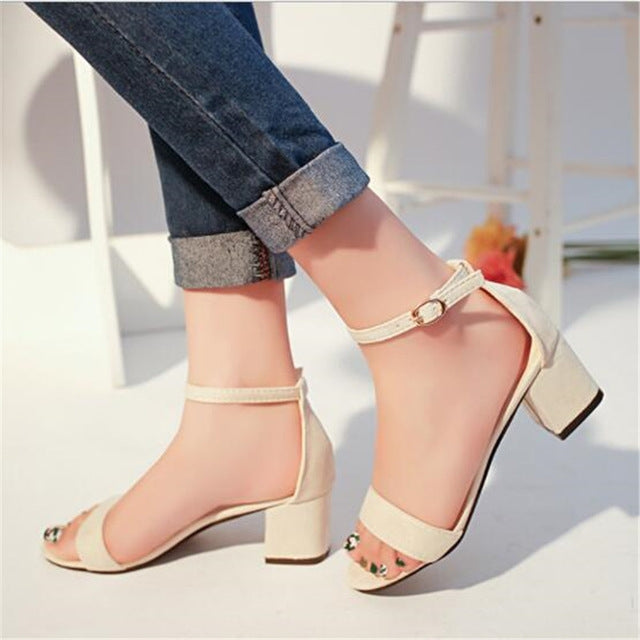 Women’s beige open-toe sandals with ankle strap buckle and block heel, side view