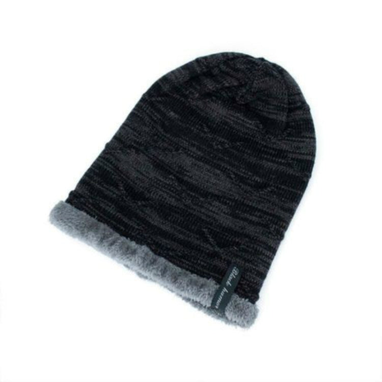Black ribbed knit winter beanie with soft gray faux-fur cuff and small logo patch