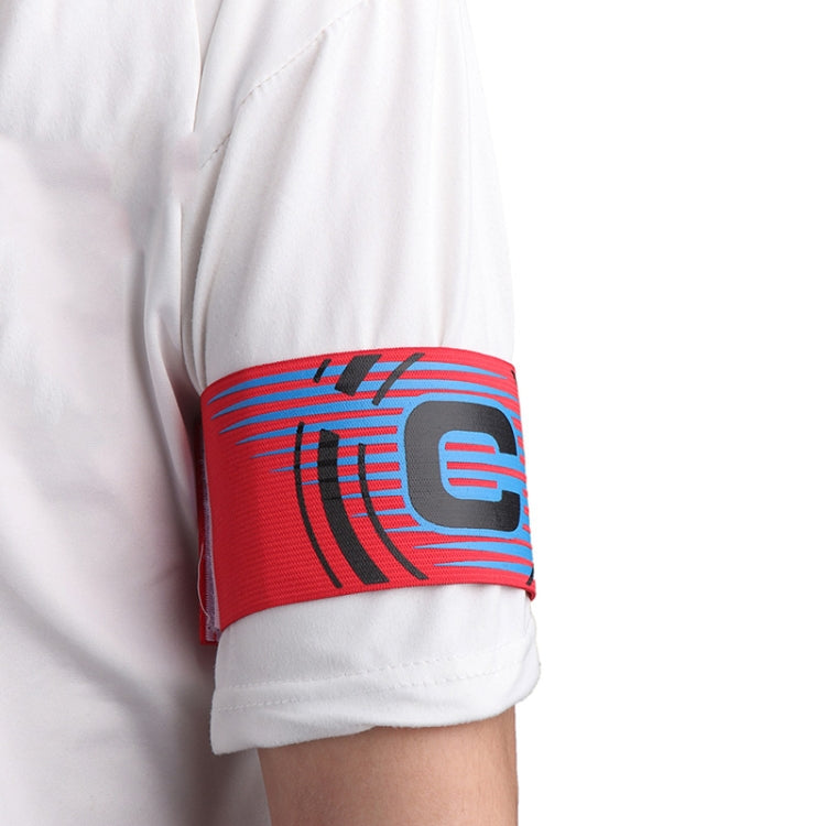 Red captain armband on white sleeve with blue and pink stripe C graphic