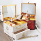 Open white music box with gold hinges, jewelry compartments, ballerina figurines and rings