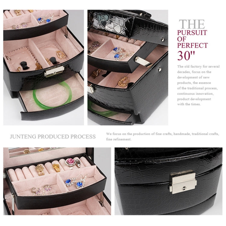 Black croc-texture jewelry box close-up of latch and layered interior compartments