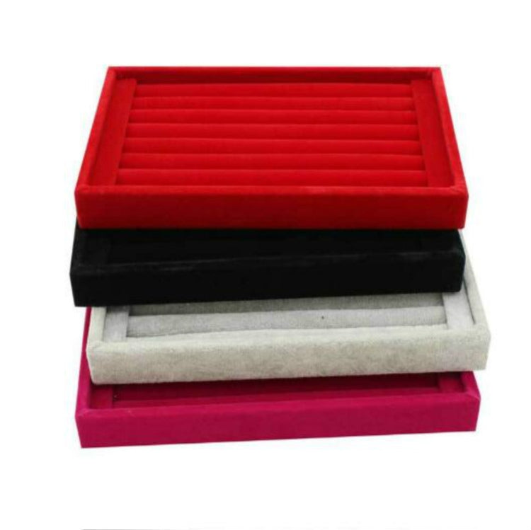 Red velvet jewelry tray with slotted insert, stacked with black and gray trays