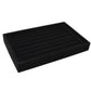 Black velvet jewelry storage tray with slotted divider rows for rings and earrings