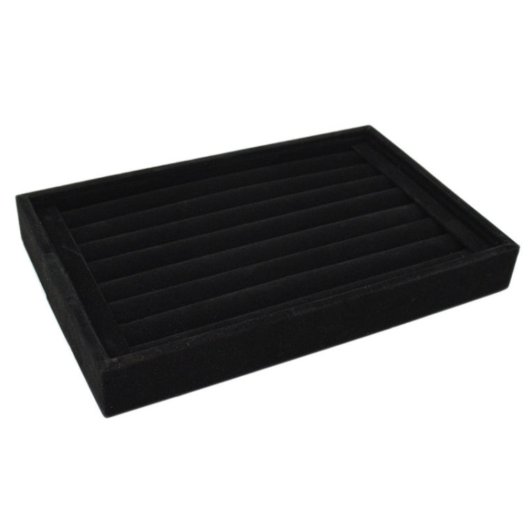 Black velvet jewelry storage tray with slotted divider rows for rings and earrings