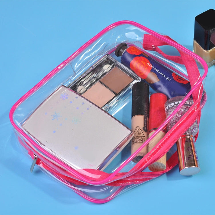 Clear PVC makeup storage bag with pink border and zipper, holds cosmetics