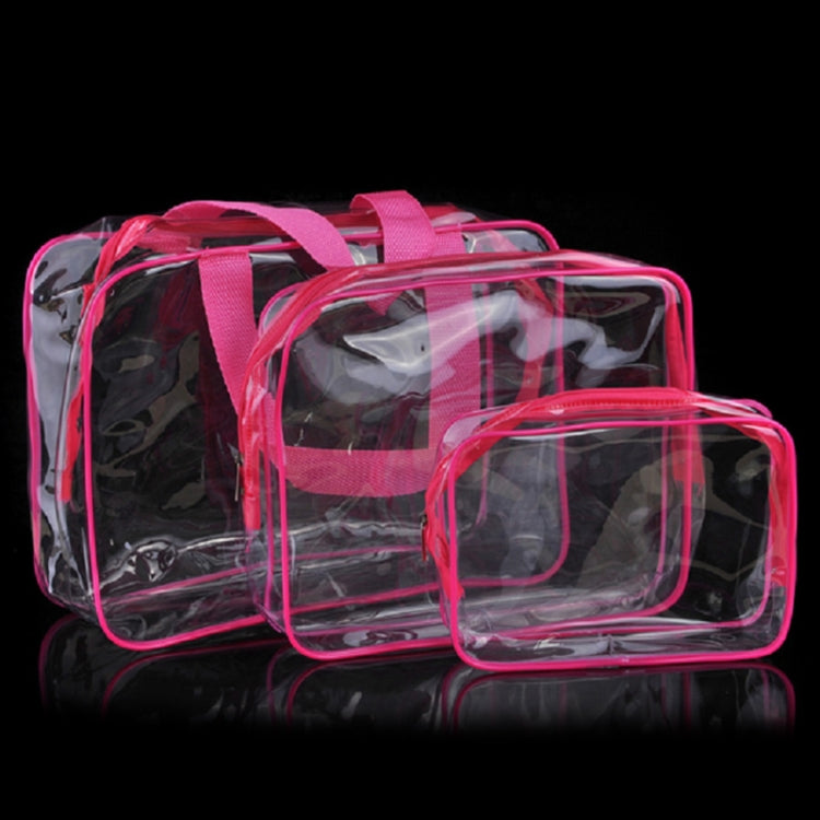 Set of transparent PVC makeup storage bags with pink trim and zippers, stacked.
