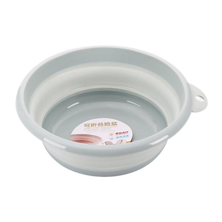 Light blue folding washbasin with side handle, round collapsible bowl.