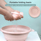 Pink portable folding washbasin with side handle, water pouring into the round tub.