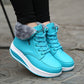 Turquoise lace-up ankle snow boots with faux fur trim and chunky white outsole