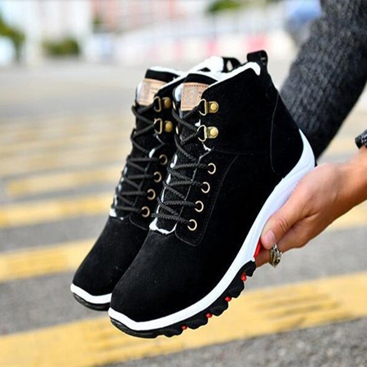 Black men's winter snow boots with lace-up closure and padded collar, side view