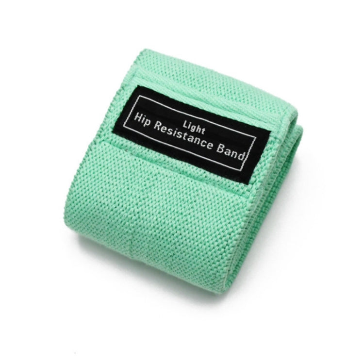 Mint hip resistance band with black label tag, rolled fabric