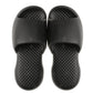 Pair of black men's plastic slide slippers with textured sole and open toe