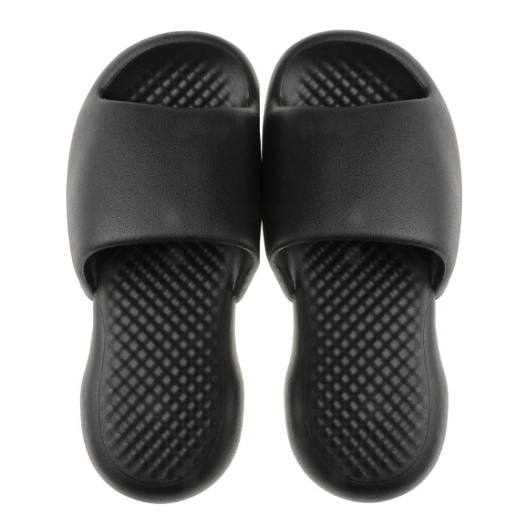 Pair of black men's plastic slide slippers with textured sole and open toe