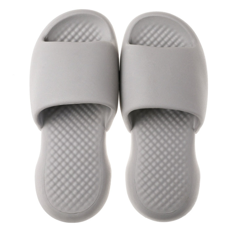 Pair of light gray men's plastic slide slippers with textured sole and open toe