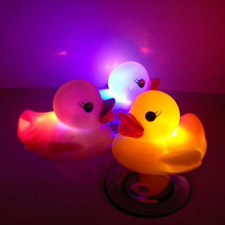 LED rubber duck bath toys, four glowing ducks with cartoon faces on dark surface