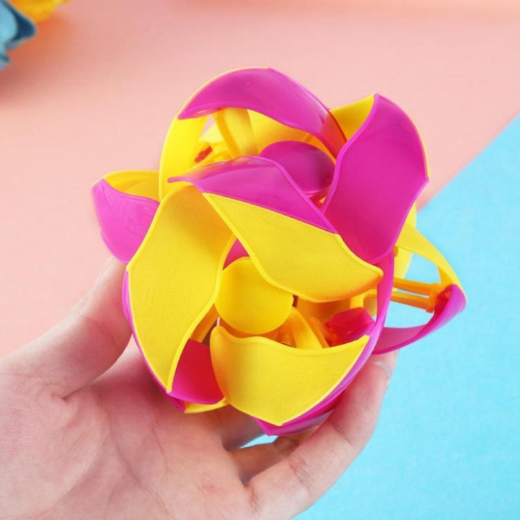 Close-up of a pink and yellow telescopic transformation magic ball with layered petals