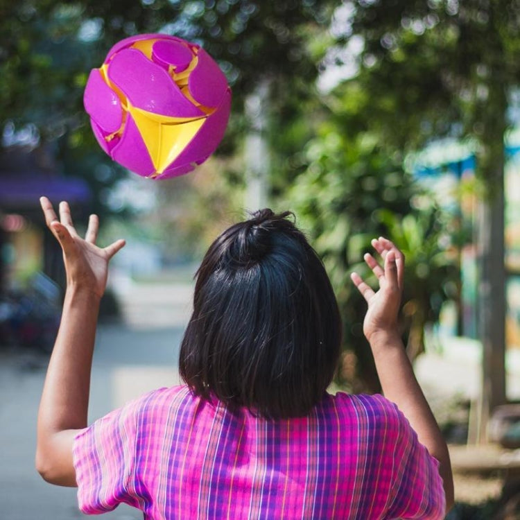 Flying pink and yellow color-changing magic ball above a child