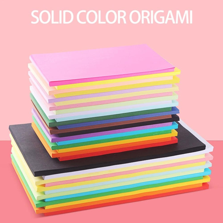Stack of solid color origami paper sheets in rainbow shades, neatly layered.
