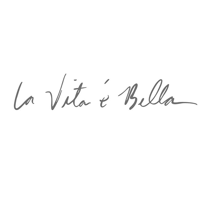 Black cursive wall decal text 'La Vita e Bella' (close-up).
