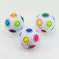 Set of three white fidget balls with multicolor circular button panels