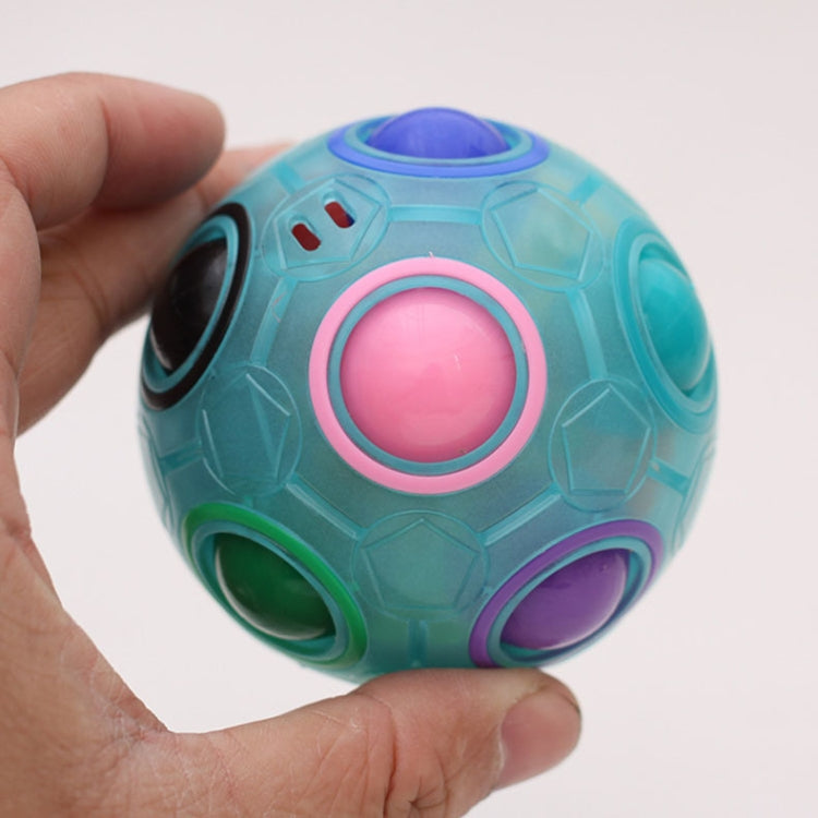 Blue fidget ball held in hand with pink center button and purple side port