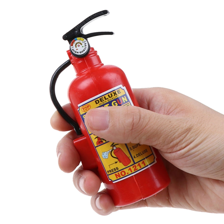 Red plastic toy squirt gun fire extinguisher held in hand, showing front label