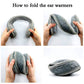 Gray earmuffs shown folded for storage, with textured knit ear pads