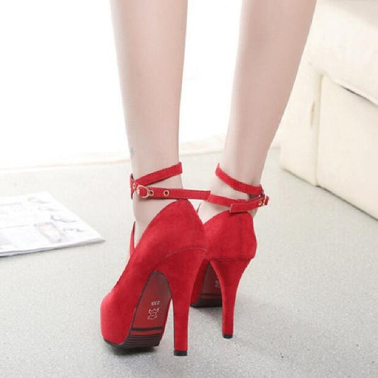 Red suede stiletto heels with round toe and ankle strap across the heel
