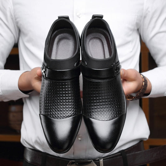 Men's black dress shoes pair with perforated panels and padded heel, shown in-hand